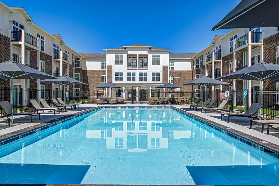 Pristine pool surrounded by apartment buildings at City's End Apartments.